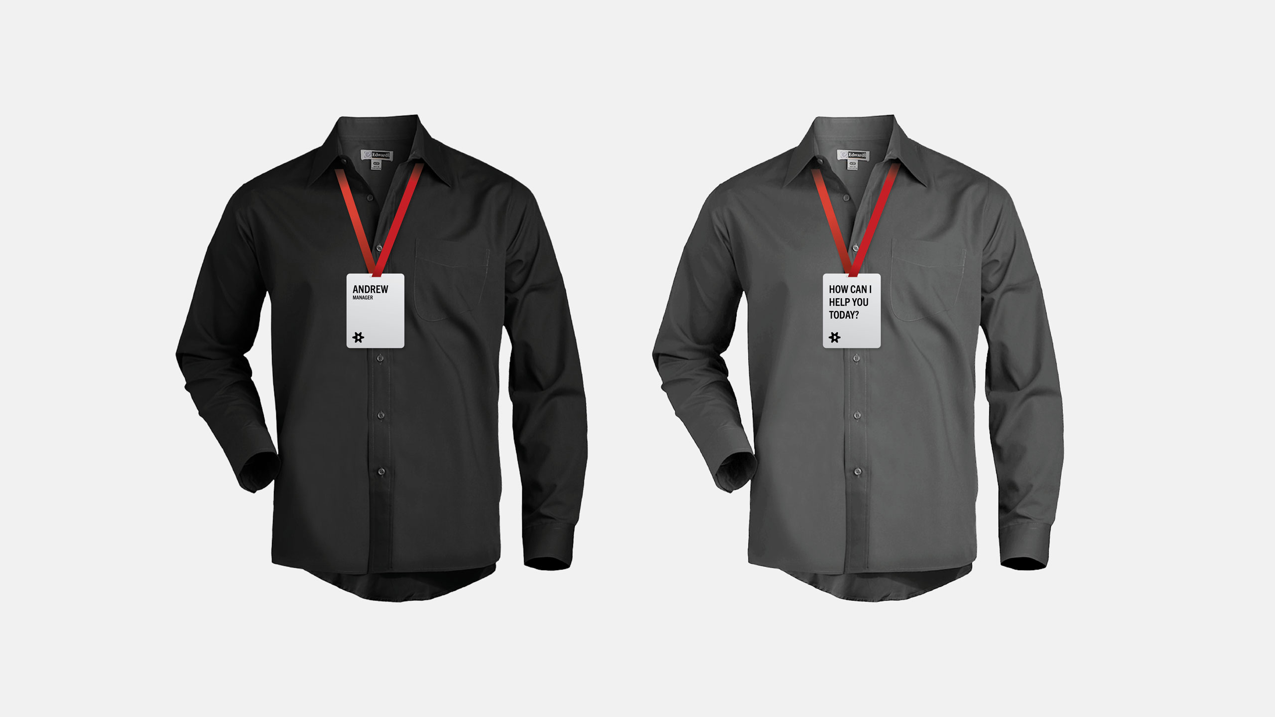 Two gray shirts are displayed against a light gray background, each with a red lanyard and a name badge for The Discount Factory. Left badge has text, "ANDREW." Right badge reads, "HOW CAN I HELP YOU TODAY?"