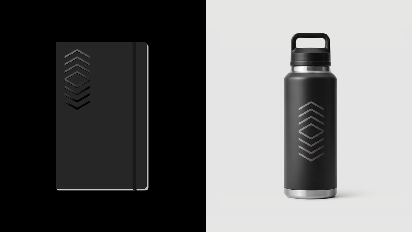 A notebook and water bottle with the Council on Vertical Urbanism's icon logo